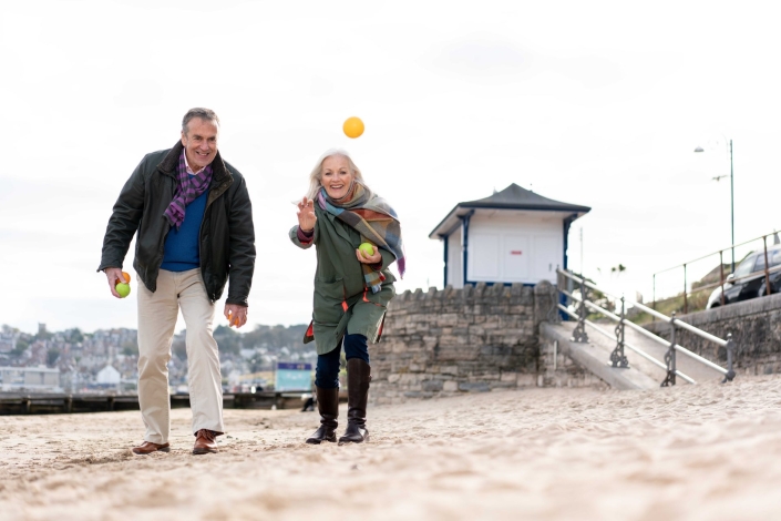 couple playing ball game on beach