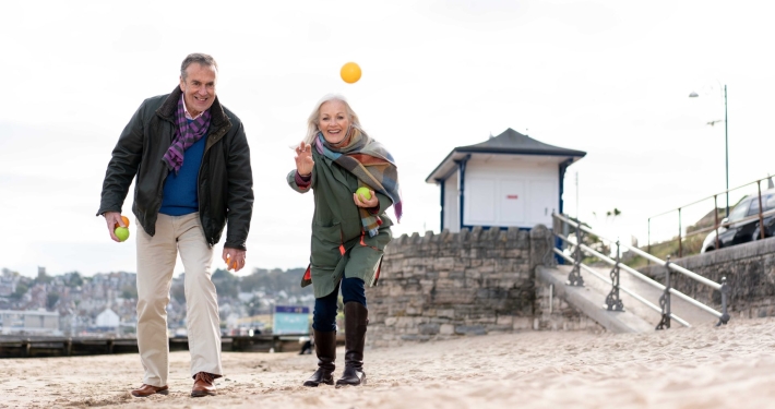 couple playing ball game on beach