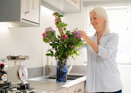 lady arranging flowers inside park home