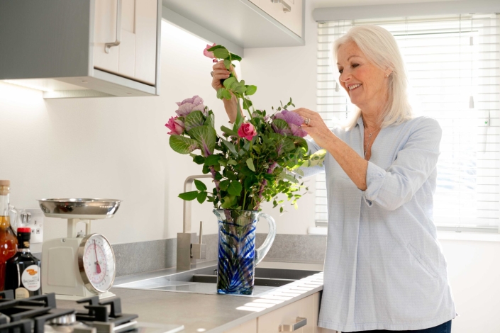 lady arranging flowers inside park home