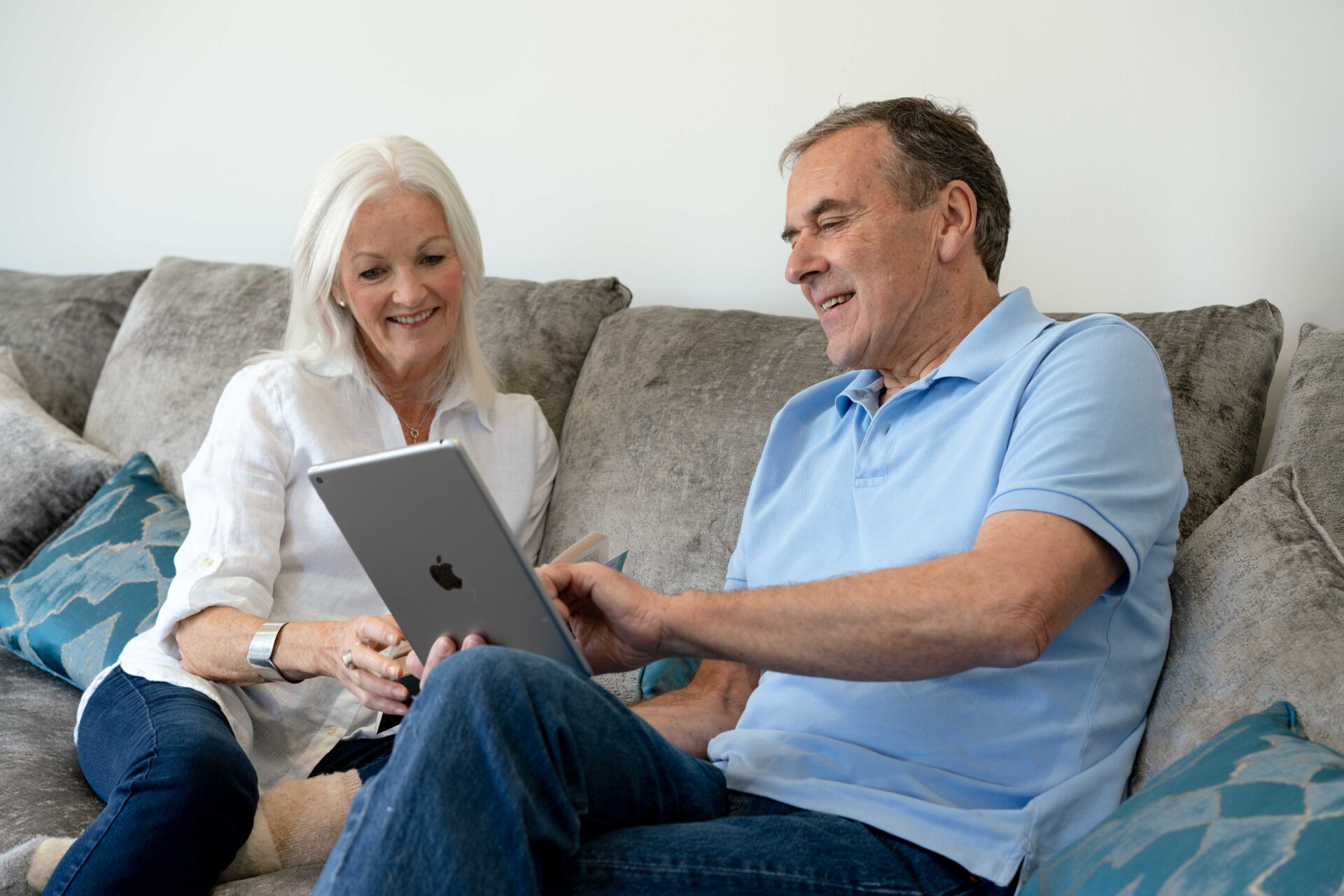 retired couple scrolling on ipad