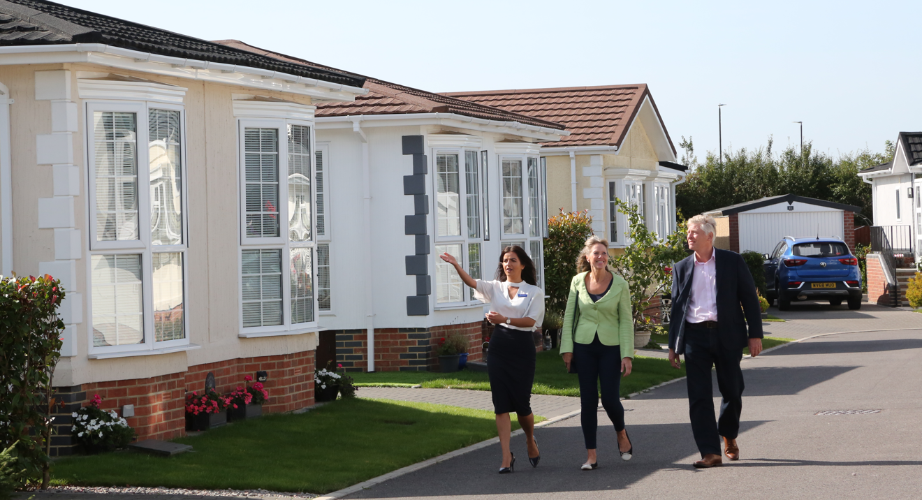 Quickmove staff member showing around couple at park open day