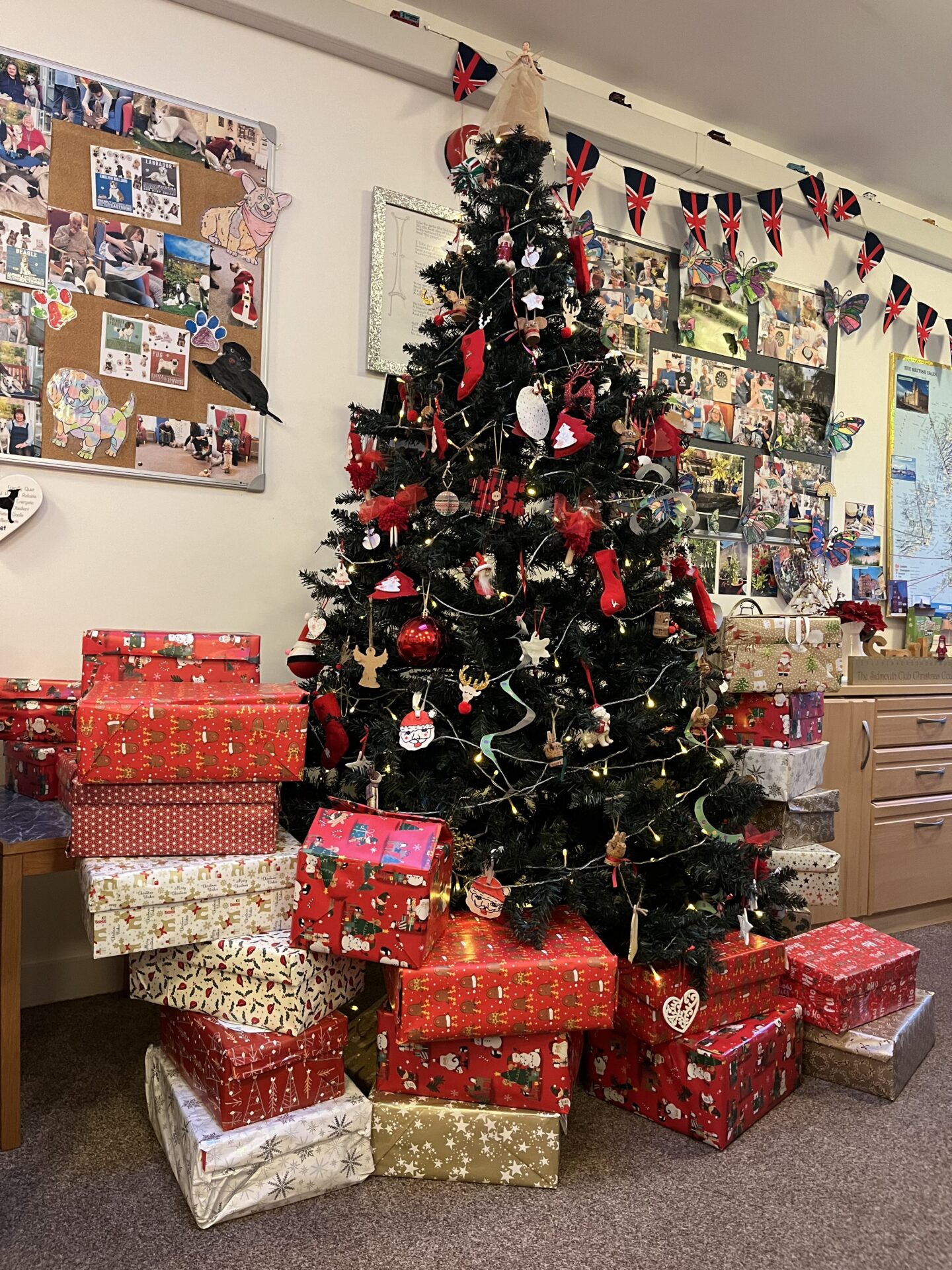 Christmas tree surrounded by stacks of wrapped Christmas presents