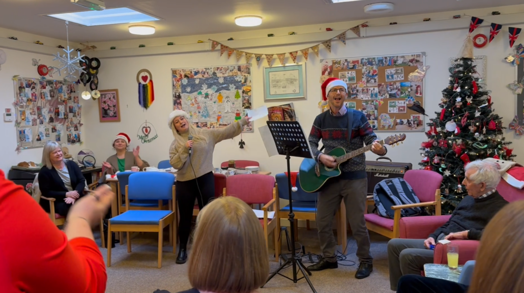 Quickmove team singing with Alzheimers Support at Christmas
